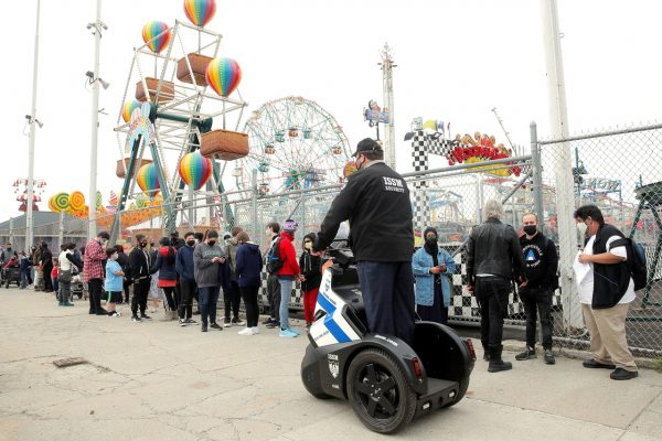 Guests line up on the first day of the Coney Island parks reopening, during the coronavirus disease (COVID-19) pandemic, in the Coney Island neighborhood of Brooklyn, New York, U.S., April 9, 2021.  REUTERS/Brendan McDermid